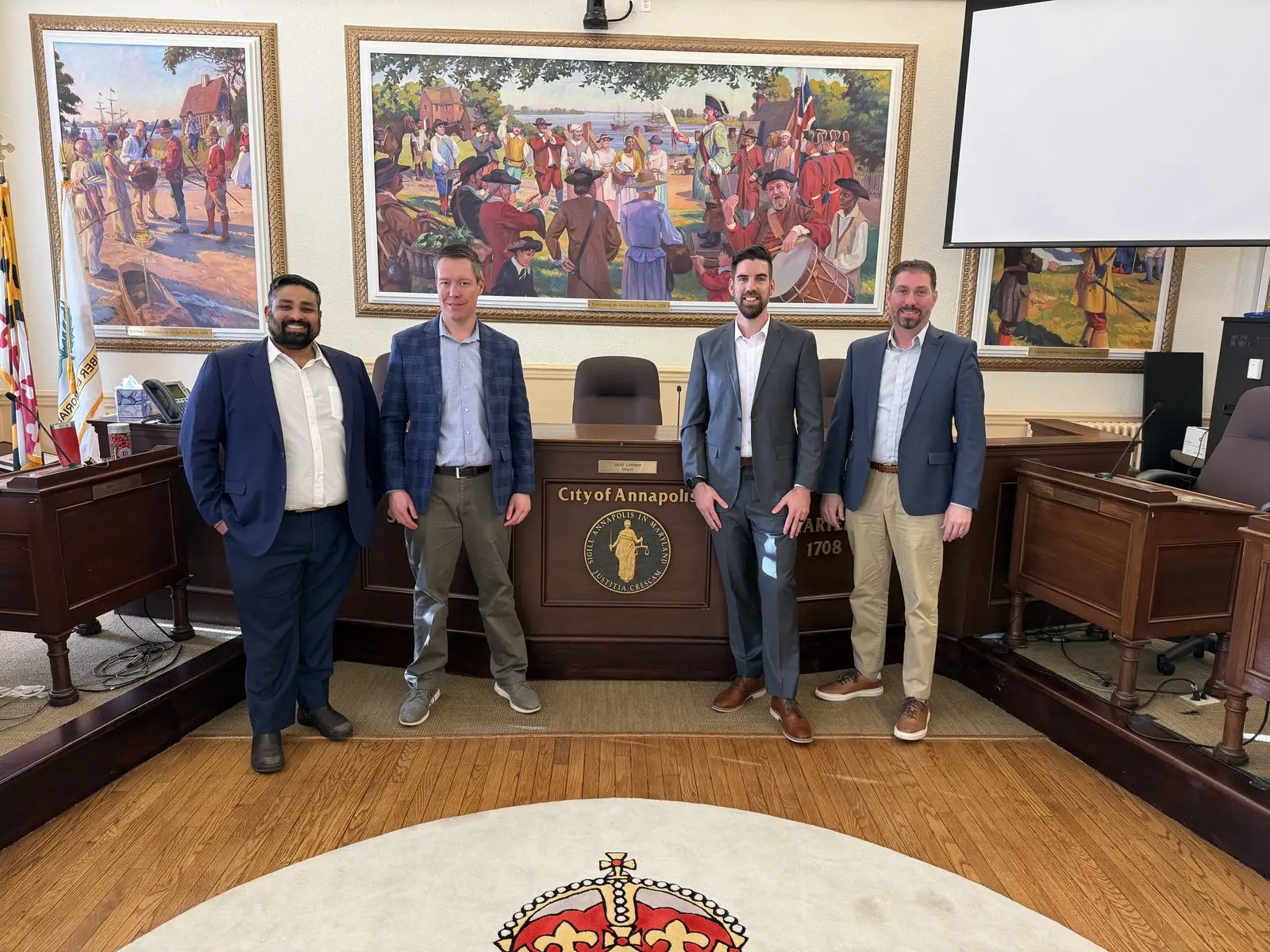 The Harbor View Consulting engagement team standing at the dais in the City of Annapolis Council Chamber